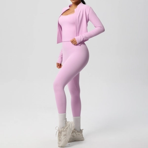 Detailed close-up of pink three-piece yoga set featuring jacket, tank top, and high waist leggings