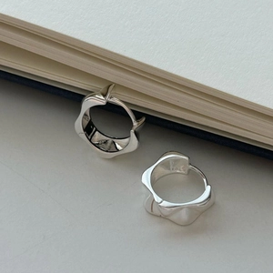 Close-up of S925 sterling silver hoop earrings with irregular liquid wave texture