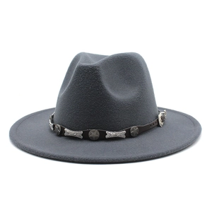 Detail of dark gray wool fedora with leather band and metallic star and bone accents