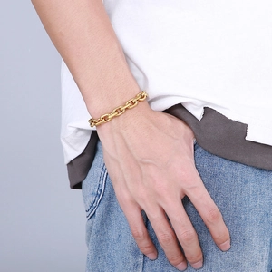 Detail of a minimalist 18K gold plated stainless steel link chain bracelet on a male wrist