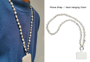 Detail of bohemian phone neck strap with marble beads and metallic hollow charms