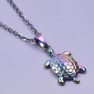 Macro view of rainbow stainless steel sea turtle pendant necklace with metallic finish