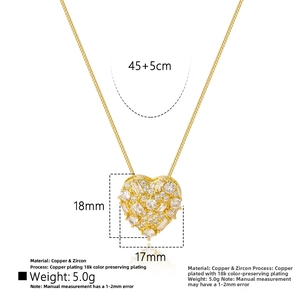 Macro shot of 18k gold heart pendant with zircon details and size measurements