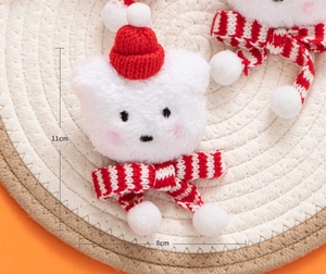 Detailed view of plush white bear pendant with red knit hat and striped scarf, 11x8cm
