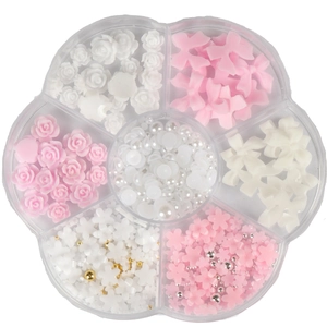 Macro detail of 6-slot storage box with white flowers, pink bows and nail pearls