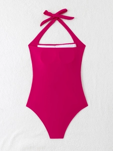 Flat lay detail of fuchsia halter neck swimsuit with bow tie and built-in pads
