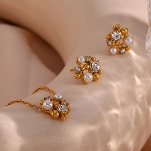 Macro shot of 18K gold plated jewelry set with white pearls and sparkling rhinestones
