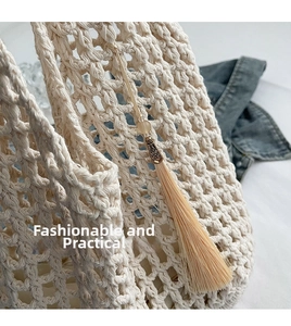 Detail of cream crochet tote bag with bohemian tassel and woven diamond pattern