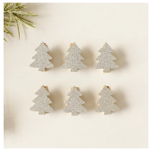 Close-up of six wooden Christmas tree clips with silver glitter finish and pine decoration
