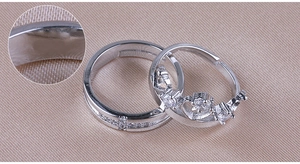 Macro detail of silver crown and minimalist band rings with sparkling zircon inlay