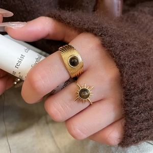 Detailed close-up of vintage gold ring set featuring radiant tiger eye stone inlays