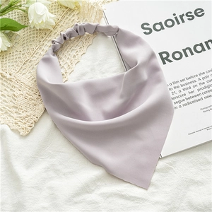 Detail of purple chiffon triangular headband with elastic strap and soft texture finish