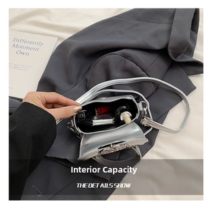 Silver metallic mini crossbody bag interior showing storage space for makeup essentials