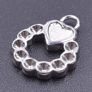 Macro view of a silver stainless steel heart pendant with round grooved base