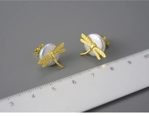 Macro shot of S925 silver dragonfly pearl earring with scale ruler measuring dimensions