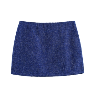 Detailed macro view of royal blue tweed skirt fabric with elegant woven texture and finish