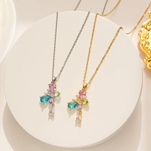 Detailed shot of gold and silver titanium butterfly pendants with multi-colored crystals