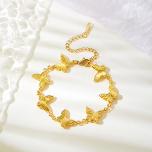 Detailed view of a gold butterfly stainless steel bracelet with lobster clasp and S.Steel logo