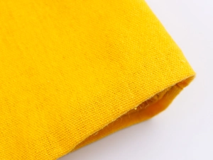 Macro view of bright yellow high-quality knitted fabric texture and detailed stitching