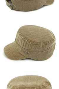 Detail of washed canvas military cap with metal buckle and logo plaque in khaki