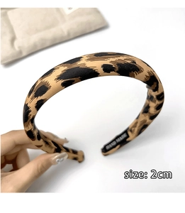 Detail of 2cm leopard print fabric headband showing handmade inner lining and texture