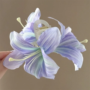 Detail of purple and green lily acrylic hair clip with a clear plastic duckbill clamp