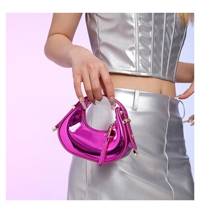 Detail of hot pink metallic patent leather handbag with gold rivets in Y2K style
