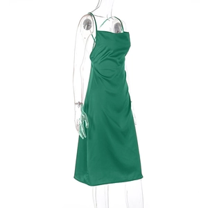 Detail of emerald green satin midi dress featuring slim fit cut and silky texture