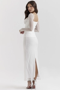 Detail view of white corset mesh maxi dress with sheer sleeves and high back slit