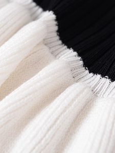 Macro shot of contrast color stitching on premium ribbed knit fabric of a classic jacket