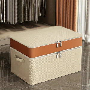 Large beige fabric quilt storage bag with brown leather accent and dual metal zippers