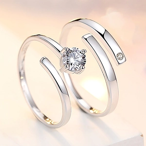 Detailed close-up of adjustable silver plated couple rings with sparkling center stones