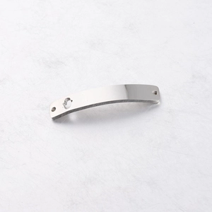 Macro shot of silver stainless steel curved connector with hollow cutout and end holes