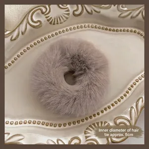Macro detail of plush hair scrunchie in grey-purple with a 5cm inner diameter measurement