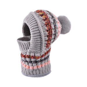 Grey knitted balaclava with colorful stripes and faux fur pompom for winter warmth