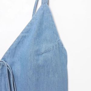 Blue denim midi dress featuring bow strap detail and high-quality textured fabric