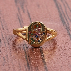 Golden Hamsa Hand open ring with colorful zircon accents on a rustic wooden background