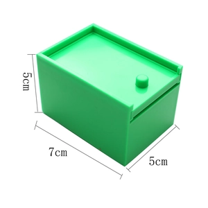 Green plastic Halloween prank spider box with 7x5x5cm dimensions on white background