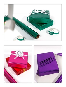Detail showing metallic gift wrapping paper in green and purple rolls with gift boxes