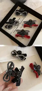Close-up of velvet bow hair claw clips with rhinestones and internal biting teeth