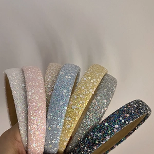 Close-up of glitter sequins on thick padded headbands in various vibrant pastel colors