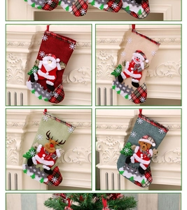 Detail view of 4 Christmas stockings with Santa, snowman, reindeer and bear embroidery