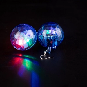 Detailed view of 70s disco ball earrings with colorful LED light glowing on metal hooks