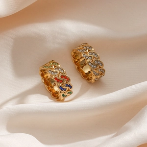 Bohemian gold Cuban chain rings with multicolored zircon stones on elegant silk fabric