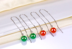 Detail of S925 silver long tassel earrings with green agate and orange chalcedony beads