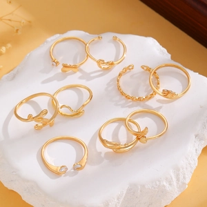 Detailed set of 9 gold-plated rings featuring butterfly, heart, and dolphin design motifs