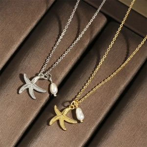 Close-up of gold and silver starfish necklaces with pearl pendants and pavé diamonds