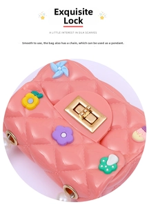 Close-up of pink quilted mini bag featuring cartoon charms and pearl chain detail