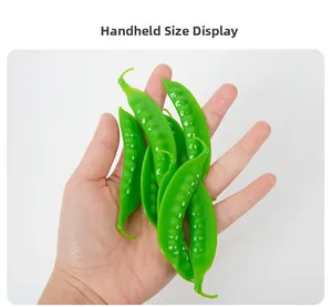 Detailed handheld view of realistic PVC green snow pea pods for props and decoration