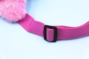 Detail of pink woven strap with adjustable plastic buckle on unicorn plush bag
